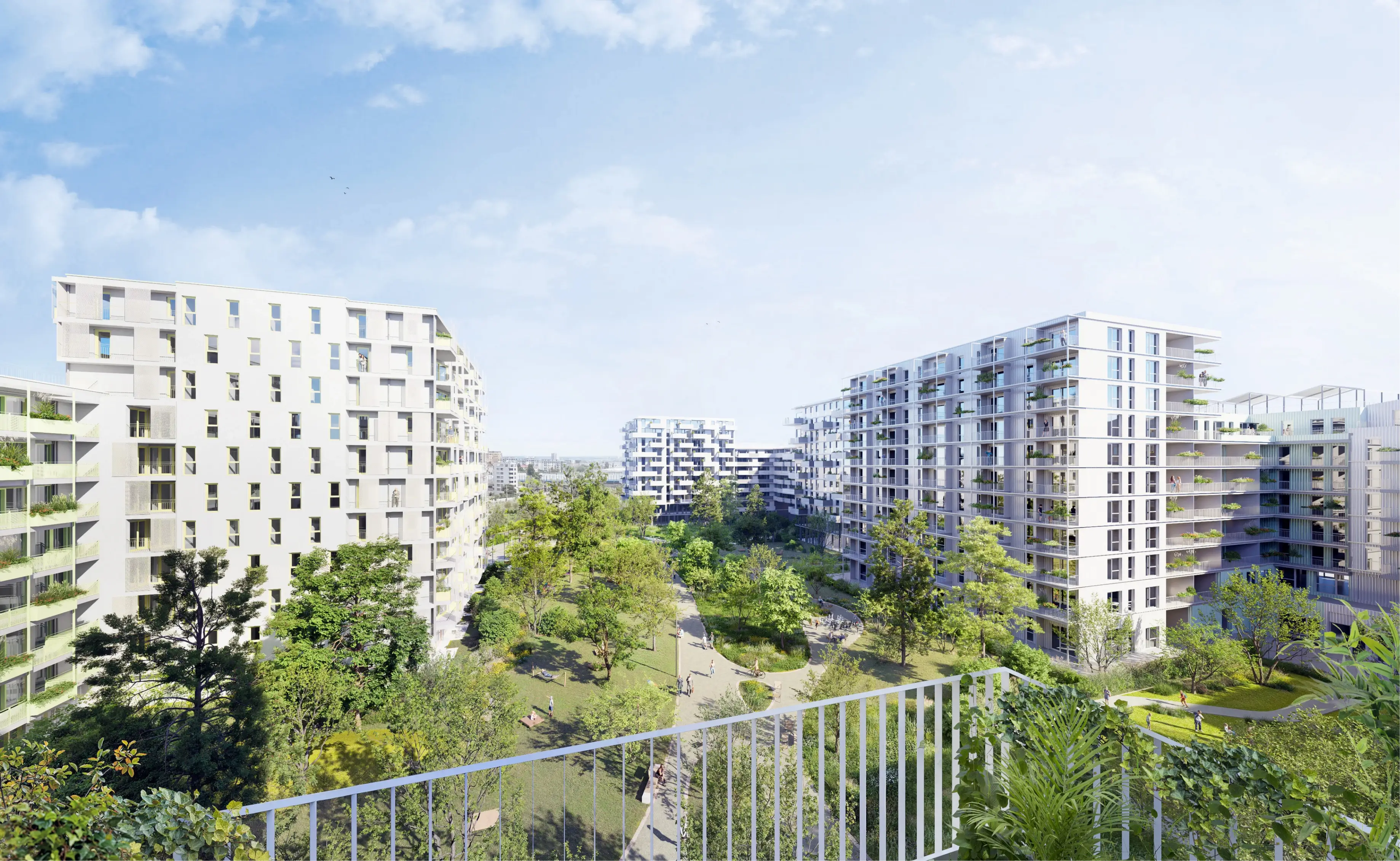 Weitläufiger Blick aus der Vogelperspektive auf ein modernes Wohnviertel mit großzügigen Grünflächen.